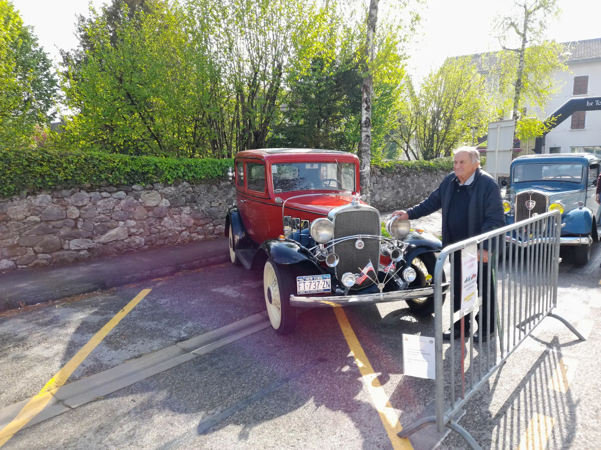 Voiture ancienne devant une barrière